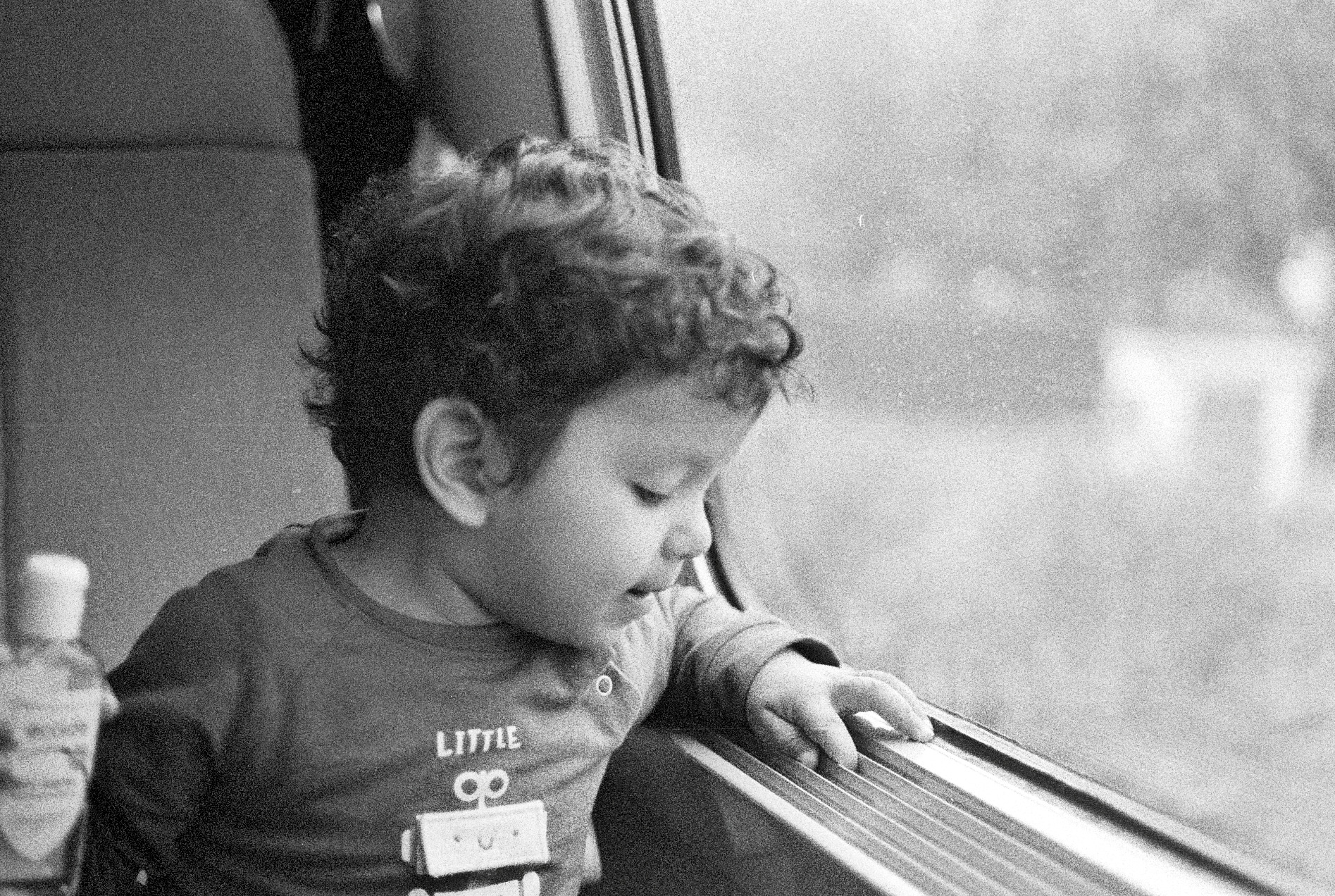 Souvenir en noir et blanc d’un enfant regardant par une fenêtre